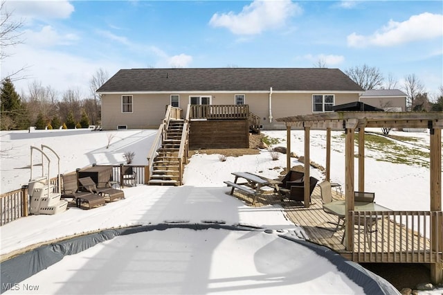 snow covered property with a deck