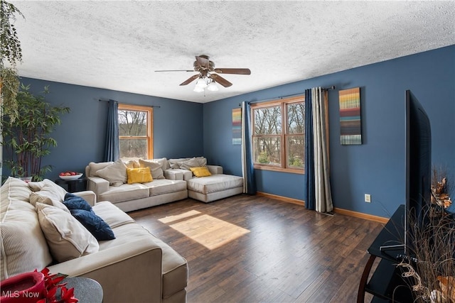 living room with ceiling fan, dark hardwood / wood-style floors, and a textured ceiling