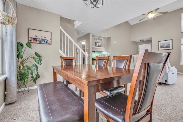 carpeted dining room featuring ceiling fan