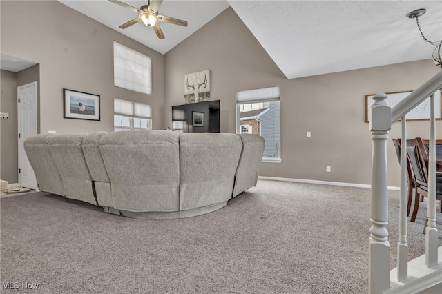 living room featuring ceiling fan, plenty of natural light, carpet flooring, and high vaulted ceiling