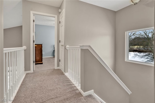 corridor featuring light carpet