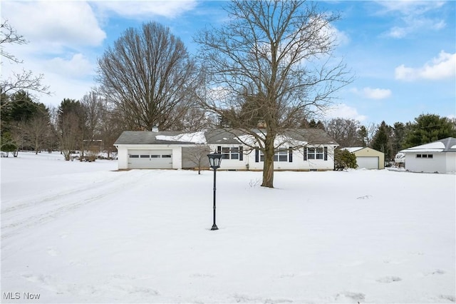 yard layered in snow featuring a garage