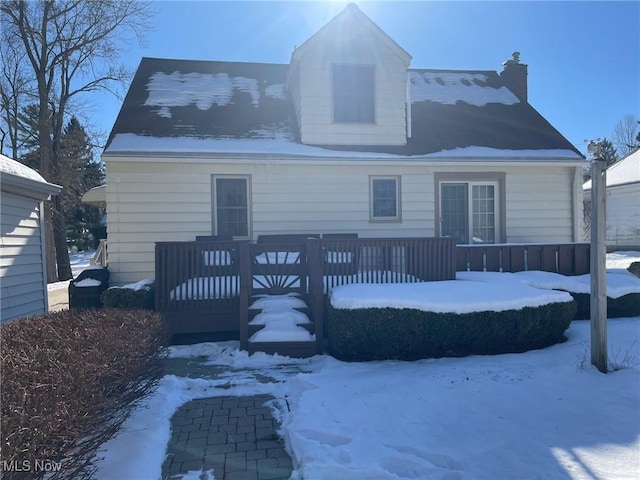 snow covered property featuring a wooden deck