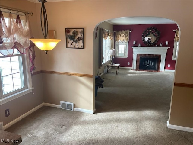 unfurnished dining area featuring a fireplace and carpet