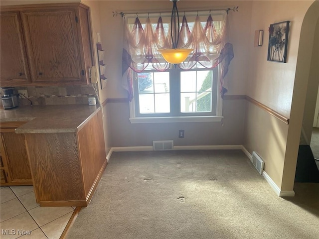 unfurnished dining area with light carpet