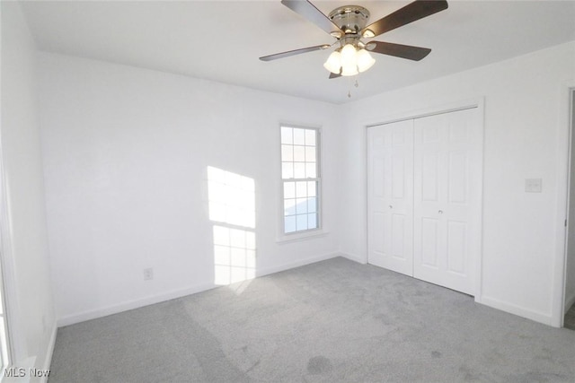 unfurnished bedroom featuring ceiling fan, carpet flooring, and a closet