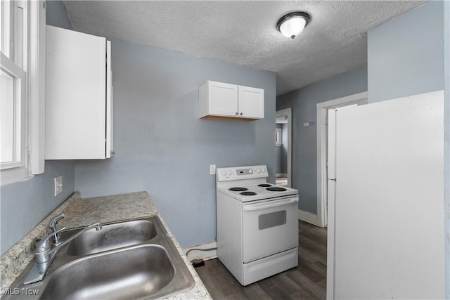 kitchen featuring sink, white appliances, dark wood-type flooring, white cabinetry, and a textured ceiling