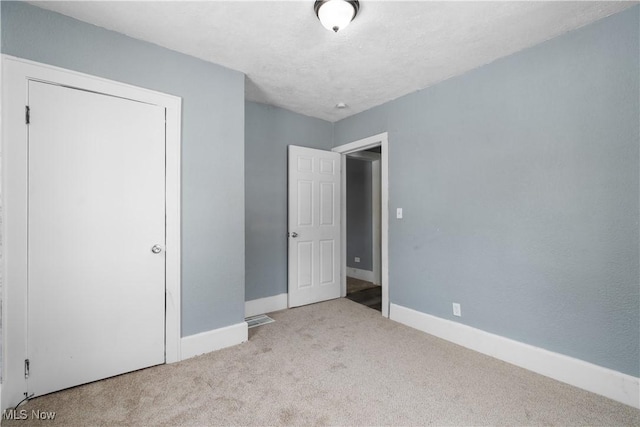 unfurnished bedroom with light colored carpet