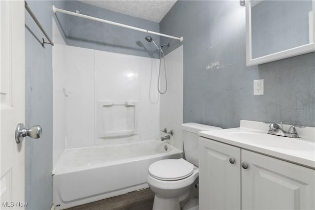 full bathroom with hardwood / wood-style floors, vanity, toilet, bathing tub / shower combination, and a textured ceiling