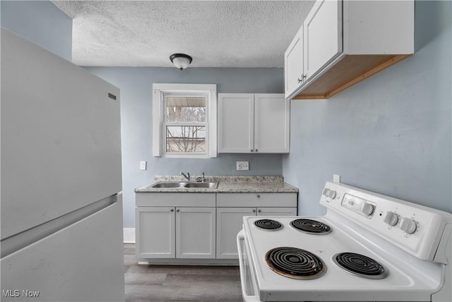 kitchen featuring white cabinetry, sink, white appliances, and a textured ceiling