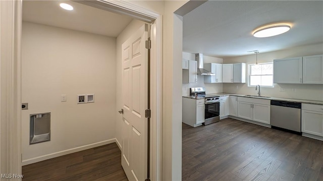 kitchen featuring stainless steel appliances, sink, white cabinets, and wall chimney exhaust hood