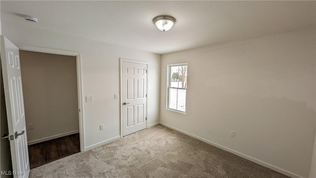 unfurnished bedroom with carpet flooring and a closet