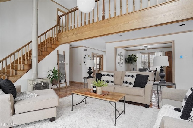 7750 W Calla Rd, Canfield, OH 44406 - tiled living area with stairs, a wood stove, ornamental molding, visible vents, and a ceiling fan