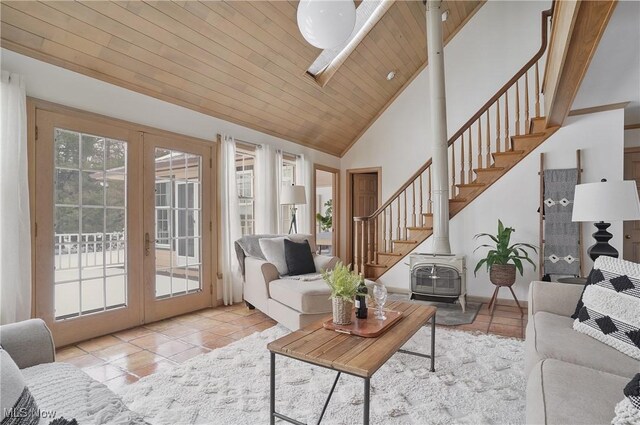 tiled living room featuring wood ceiling, high vaulted ceiling, french doors, and a wood stove