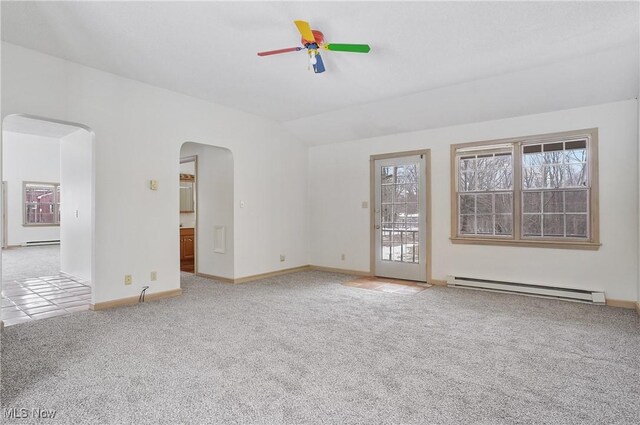 unfurnished room featuring ceiling fan, vaulted ceiling, carpet, and a baseboard heating unit