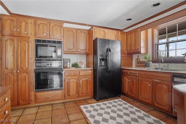 kitchen with ornamental molding, sink, light tile patterned floors, and black appliances