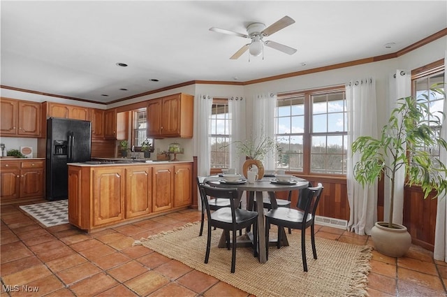 kitchen featuring ornamental molding, black fridge, light tile patterned flooring, and ceiling fan