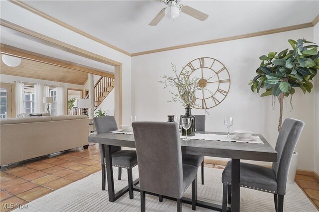 tiled dining area with crown molding and ceiling fan