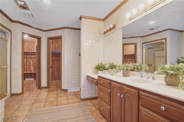 bathroom with crown molding, tile patterned floors, and vanity