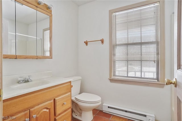 bathroom with tile patterned flooring, vanity, a baseboard heating unit, and toilet