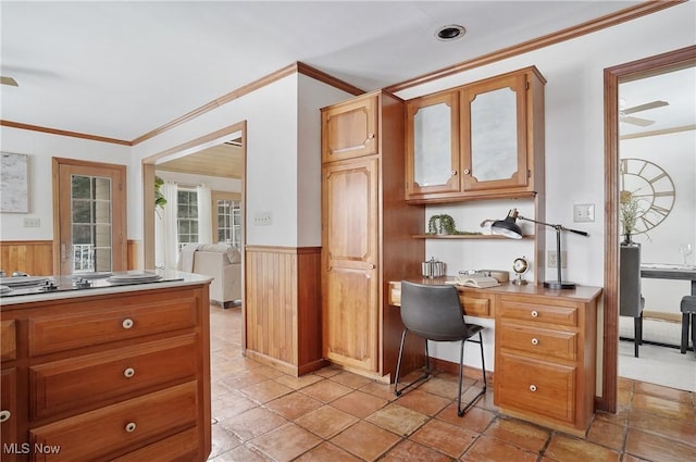 office featuring crown molding and wood walls