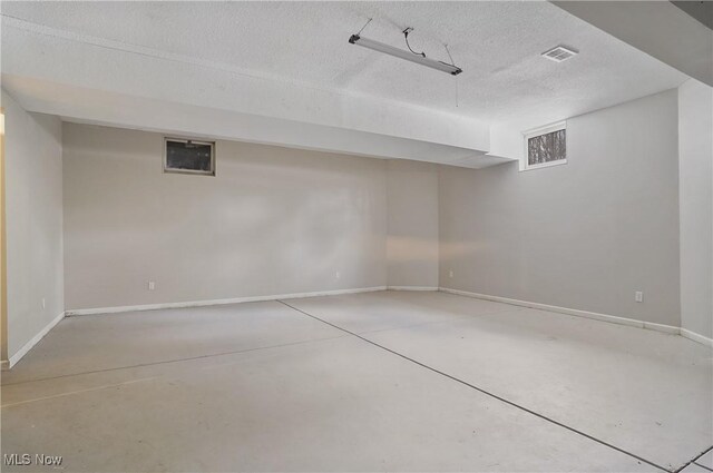 basement featuring a textured ceiling