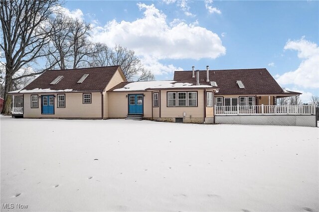 view of snow covered rear of property