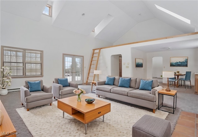7750 W Calla Rd, Canfield, OH 44406 - living area featuring a baseboard radiator, french doors, high vaulted ceiling, arched walkways, and a skylight