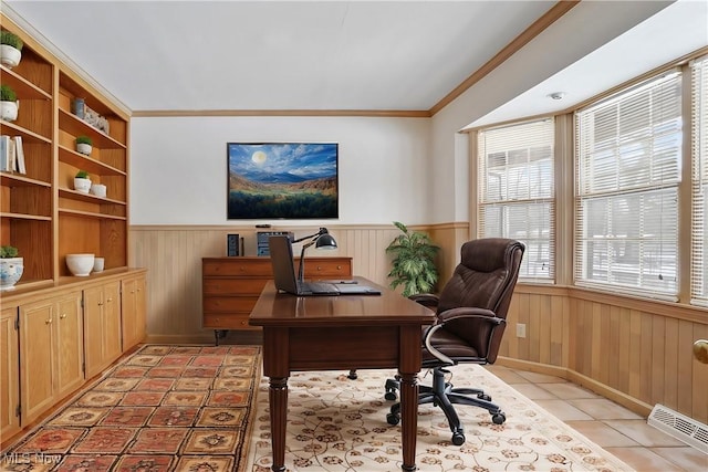 tiled home office featuring ornamental molding and built in shelves