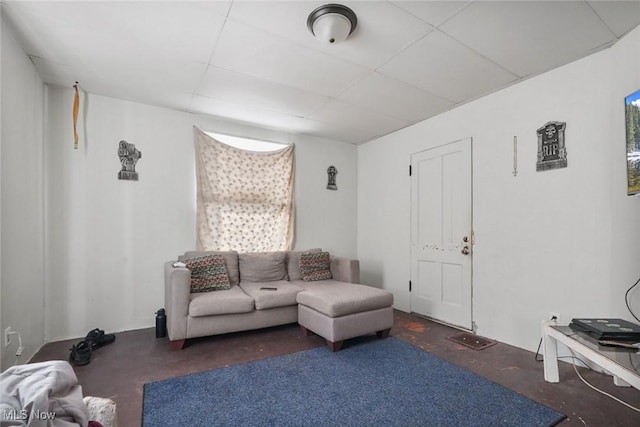 living room featuring a paneled ceiling