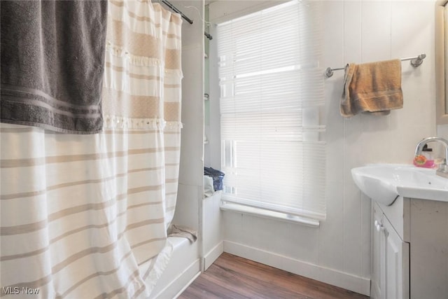 bathroom featuring vanity, hardwood / wood-style flooring, and shower / bath combo