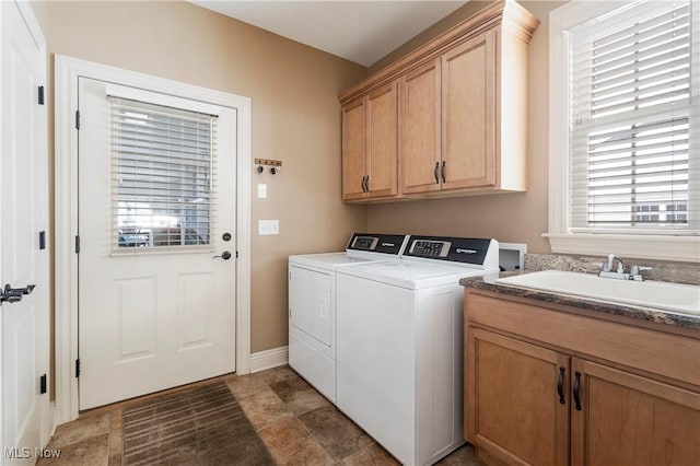 washroom featuring cabinets, separate washer and dryer, and sink