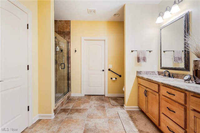 bathroom with a shower with door, vanity, and toilet