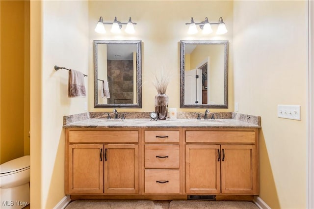 bathroom with vanity and toilet