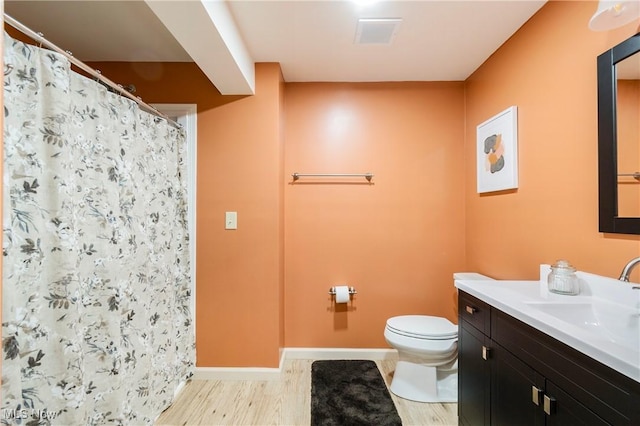 bathroom with vanity, hardwood / wood-style floors, a shower with shower curtain, and toilet