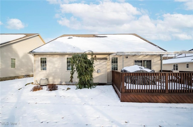 snow covered rear of property with central air condition unit and a deck