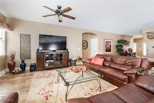 living room with light tile patterned floors and ceiling fan