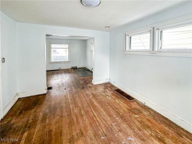 3235 W 94th St, Cleveland, OH 44102 - empty room with a healthy amount of sunlight and hardwood / wood-style floors