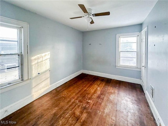 3235 W 94th St, Cleveland, OH 44102 - spare room featuring dark wood-type flooring and ceiling fan