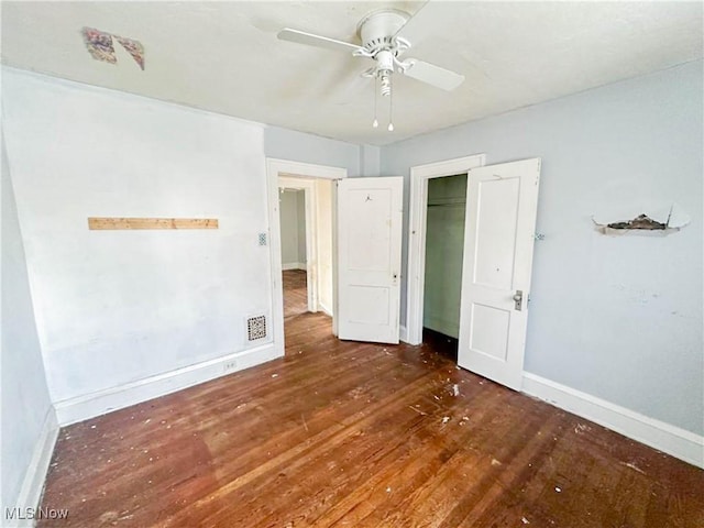 3235 W 94th St, Cleveland, OH 44102 - unfurnished bedroom with dark hardwood / wood-style flooring, ceiling fan, and a closet