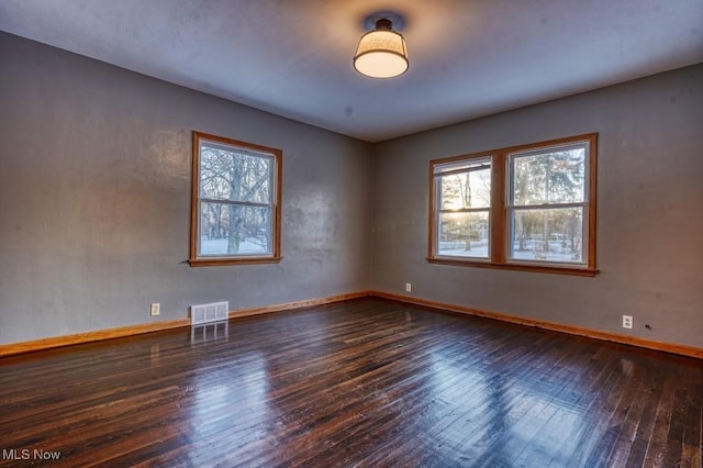 empty room featuring dark wood-type flooring