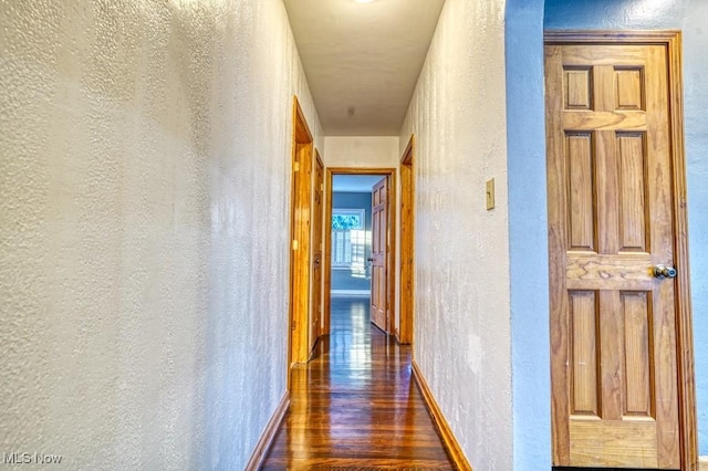 corridor featuring dark hardwood / wood-style flooring