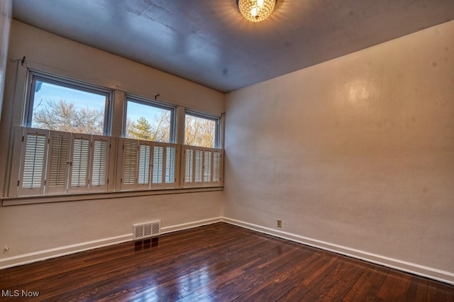 empty room featuring dark hardwood / wood-style flooring