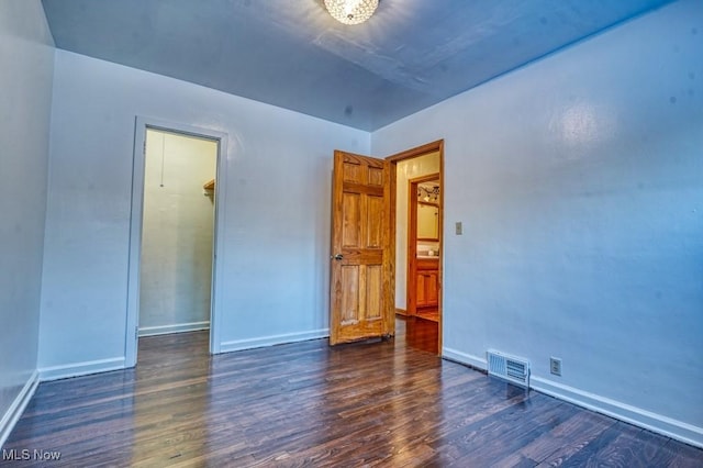 empty room with dark hardwood / wood-style floors