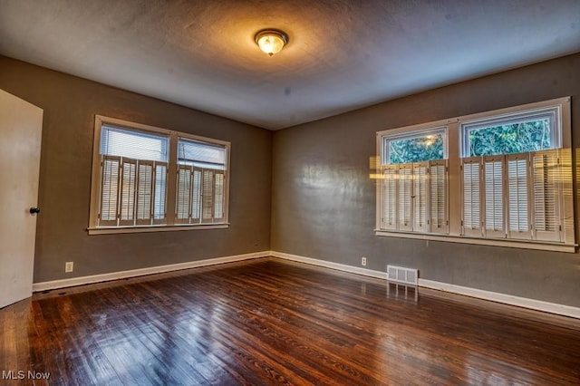 unfurnished room featuring dark hardwood / wood-style flooring