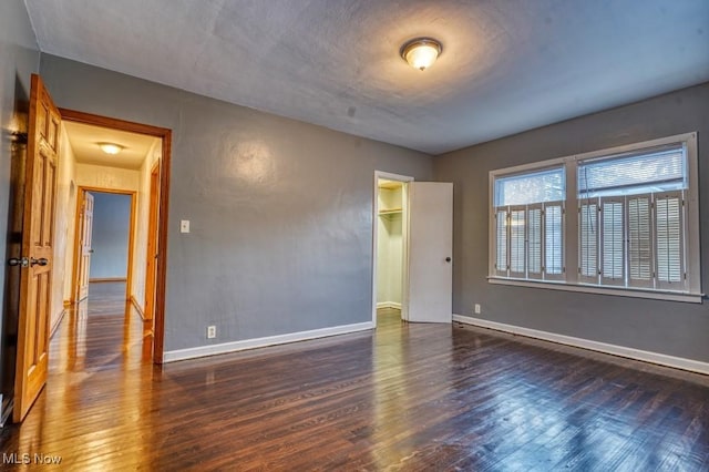 unfurnished room featuring dark hardwood / wood-style flooring