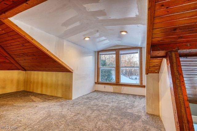 bonus room featuring lofted ceiling, carpet flooring, and wood ceiling