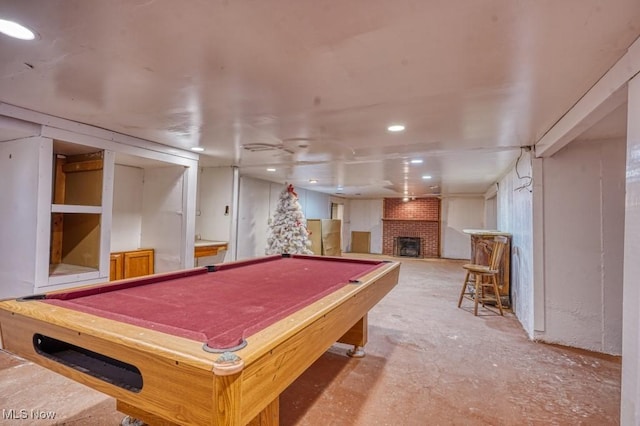 playroom featuring a brick fireplace and billiards