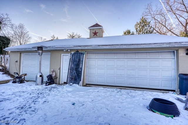 view of snow covered garage