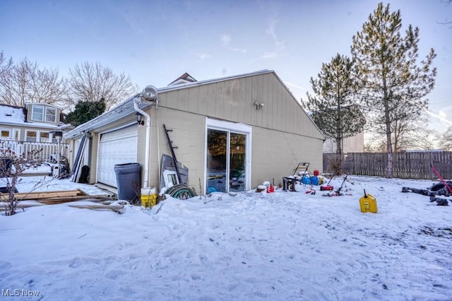 view of snow covered rear of property